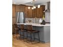 Modern kitchen featuring stainless steel appliances, a large island, and stylish pendant lighting at 2515 N Gaylord St, Denver, CO 80205