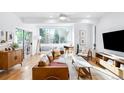 Living room with hardwood floors, exposed beams, large windows, and a sliding door to a private balcony at 3334 Tejon St # 1, Denver, CO 80211