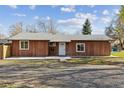 Inviting single-story home with a spacious front yard and a classic design at 8182 3Rd Ave, Arvada, CO 80007