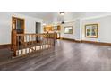 Open-concept living area with natural light, hardwood floors, and staircase at 8182 3Rd Ave, Arvada, CO 80007