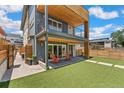 A backyard offers a seamless transition with patio seating and well-maintained artificial turf at 3657 Pecos St, Denver, CO 80211