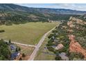 Great land and location showcasing beautiful views, including a large field and neighboring mountains providing a serene backdrop at 5085 Red Rock Dr, Larkspur, CO 80118