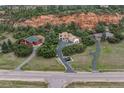 Spacious home nestled in lush greenery, boasting a private driveway and close proximity to nearby residences and surrounding nature at 5085 Red Rock Dr, Larkspur, CO 80118