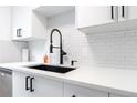 Stylish kitchen featuring white quartz countertops, a deep sink and white subway tile backsplash at 1111 Maxwell Ave # 233, Boulder, CO 80304