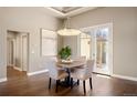 Elegant dining area with hardwood floors, stylish chandelier, and modern decor at 1803 Avenida Del Sol, Castle Rock, CO 80104