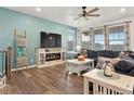 Comfortable living room features a decorative fireplace, large windows, and an open layout at 965 Peach Leaf Ln, Elizabeth, CO 80107
