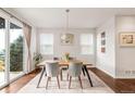 Stylish dining room with modern light fixture, wood floors, slider to yard and views at 3231 Riverwood Way, Castle Rock, CO 80109