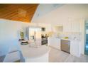 Bright kitchen with stainless steel appliances, white cabinets, and breakfast bar at 665 S Meade St, Denver, CO 80219