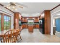 Traditional kitchen with wood cabinets, granite countertops, a center island, and stainless steel appliances at 10330 Melody Dr, Northglenn, CO 80260
