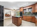 Traditional kitchen with wood cabinets, granite countertops, a center island, and stainless steel appliances at 10330 Melody Dr, Northglenn, CO 80260