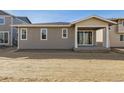 Back exterior of the house showcasing sliding glass doors to the patio and neutral-colored siding at 24779 E 39Th Ave, Aurora, CO 80019