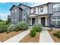 Beautiful townhome features a well-manicured lawn and inviting entrance pathways at 185 Ambrose St, Erie, CO 80516