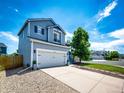 Two-story home with a two-car garage, blue siding and a concrete driveway at 8930 Apache Plume Dr, Parker, CO 80134