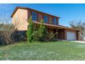Two story home with a covered porch supported by wooden posts and mature landscaping at 11098 Fairfax Way, Thornton, CO 80233