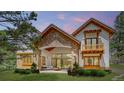Stunning home with stone accents, a covered patio, and lush landscaping at 11790 Huckleberry Drive Dr, Franktown, CO 80116