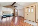 Spacious living room with fireplace, hardwood floors, and vaulted ceilings at 10262 W Ida Ave # 243, Littleton, CO 80127