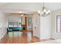 Open-concept living area with brick fireplace, hardwood floors, and bright natural light at 10262 W Ida Ave # 243, Littleton, CO 80127