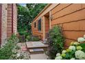 Side view showcasing a cozy entrance with garden, wooden details and lovely flower accents at 10262 W Ida Ave # 243, Littleton, CO 80127