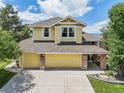 Charming two-story home featuring stone accents, a well-maintained lawn, and a spacious two-car garage at 9385 Prairie View Dr, Highlands Ranch, CO 80126