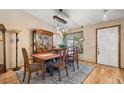 A beautifully staged dining room with hardwood floors, a vintage hutch, and a stylish light fixture at 11313 Haswell Dr, Parker, CO 80134
