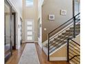 Bright and spacious entryway with hardwood floors and staircase at 2800 S Dexter Way, Denver, CO 80222