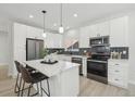 Modern kitchen featuring white cabinets, quartz countertops, and stainless steel appliances at 1835 S Lincoln St, Denver, CO 80210