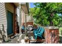 Inviting covered patio with blue chairs, perfect for outdoor relaxation and entertaining guests at 10035 E Mexico Ave, Aurora, CO 80247