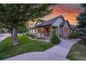 Charming ranch home with stone accents and landscaped front yard at 5930 S Yank Way, Littleton, CO 80127