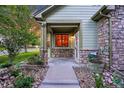 Inviting front porch with stone accents and entryway at 5930 S Yank Way, Littleton, CO 80127