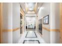 Hallway featuring elevator access, decorative mailboxes, and neutral color palette, showcasing convenience and style at 301 Inverness S Way # 202, Englewood, CO 80112