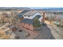 Aerial view of a landscaped yard and a brick two-story home with a patio and a well-maintained garden at 767 Ellis St, Golden, CO 80401