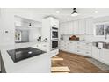 Stylish kitchen with stainless appliances, quartz countertops, and sleek white cabinets at 767 Ellis St, Golden, CO 80401