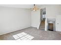 Bright living room featuring vaulted ceiling and a staircase leading upstairs at 17593 E Temple Dr, Aurora, CO 80015