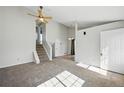 Spacious living area with high ceilings, staircase access, and abundant natural light at 17593 E Temple Dr, Aurora, CO 80015