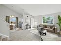 Cozy living room with neutral tones, a large window, and an open floor plan at 17593 E Temple Dr, Aurora, CO 80015