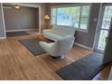Sunlit living room featuring stylish furniture, hardwood floors, and a large window with a view at 5142 S Pennsylvania St, Littleton, CO 80121