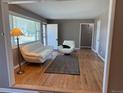 Bright living room with hardwood floors, neutral paint and plentiful natural light from large window at 5142 S Pennsylvania St, Littleton, CO 80121