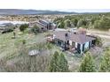 Scenic backyard view with a deck, hot tub, trampoline, and lush greenery overlooking a serene lake at 1285 Spinnaker Trl, Monument, CO 80132