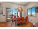 Elegant dining room with modern light fixture and views at 180 N Cook St # 509, Denver, CO 80206