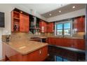 Modern kitchen with custom cabinets, stainless steel appliances, granite countertops, and ample natural light at 180 N Cook St # 509, Denver, CO 80206