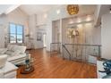 Open-concept living room showcasing high ceilings, hardwood floors, and stylish chandeliers at 180 N Cook St # 509, Denver, CO 80206