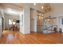 Open-concept living room and dining area with unique lighting fixtures and lots of space at 180 N Cook St # 509, Denver, CO 80206
