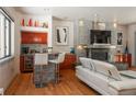 Modern living room with a stone fireplace, bar seating, and sleek design at 180 N Cook St # 509, Denver, CO 80206