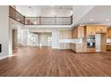 Bright, open-concept living space with wood floors, high ceilings, and a modern kitchen, perfect for entertaining at 3976 Breakcamp Ct, Castle Rock, CO 80108