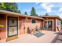 Inviting back porch with table and chairs perfect for outdoor relaxation and entertaining at 7284 Willa Ln, Evergreen, CO 80439