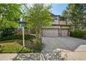 Inviting two-story home with stone accents, a two-car garage, and a well-landscaped front yard, for sale at 13075 Tamarac St, Thornton, CO 80602