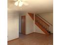 Living room showcases a wooden staircase, wood floors, a ceiling fan, and fresh paint throughout at 473 N Banner St # C, Elizabeth, CO 80107