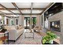 Bright and airy living room with modern fireplace, stylish furniture, and seamless access to the outdoor area at 852 Pontiac St, Denver, CO 80220