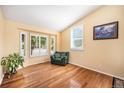 Bright living room featuring hardwood floors, large windows, and comfortable seating at 1010 Home Farm Cir, Denver, CO 80234