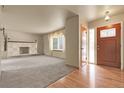 Inviting living room with hardwood floors, plush carpeting and a stunning fireplace at 1160 Johnson St, Lakewood, CO 80215